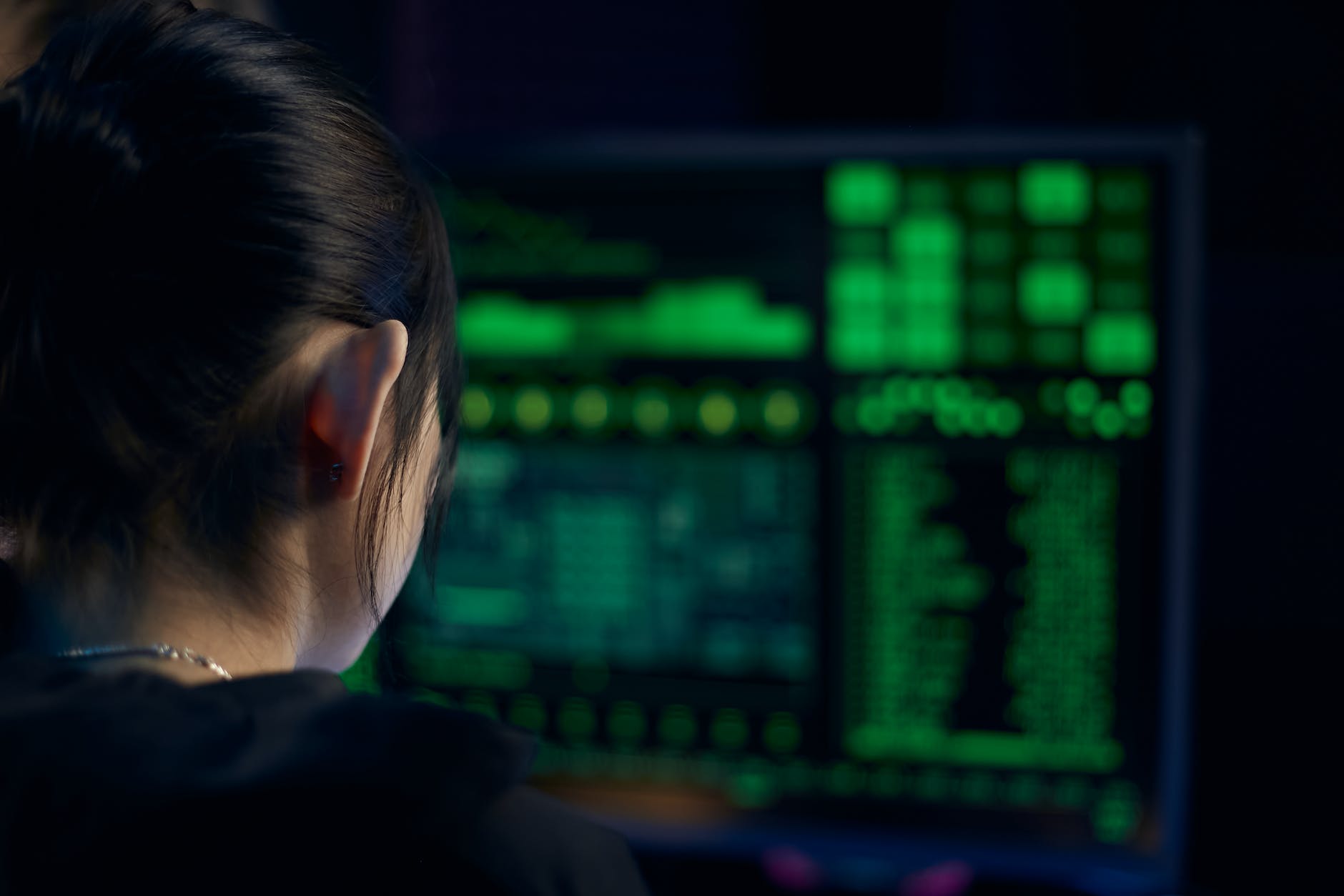 woman in black shirt looking at neon lights